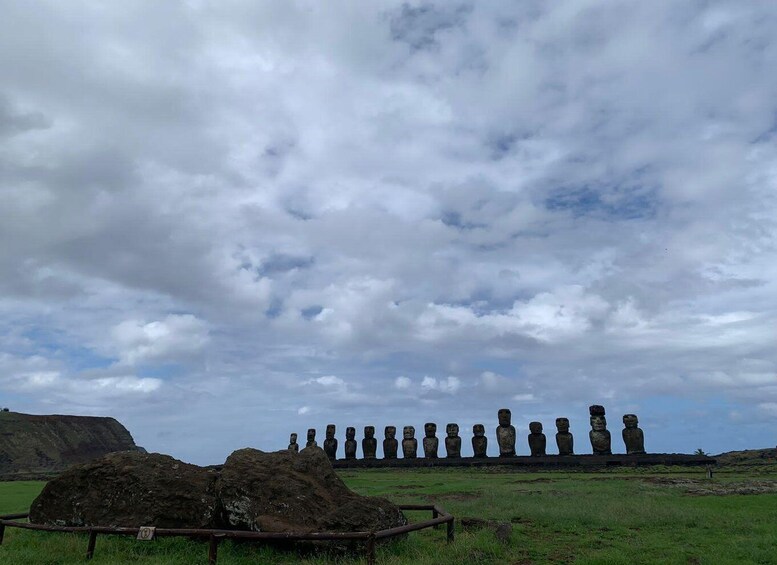 A row of Moai statues on Easter Island under a cloudy sky. 1