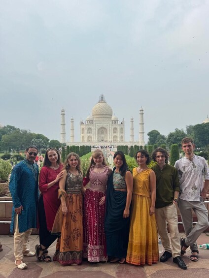 A group of people standing in front of the Taj Mahal. 2