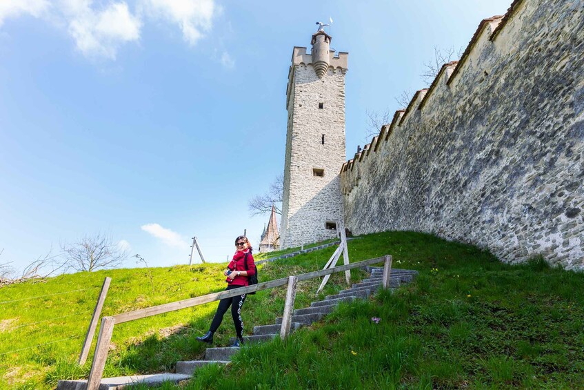 A person climbing stone steps towards a castle tower. 2