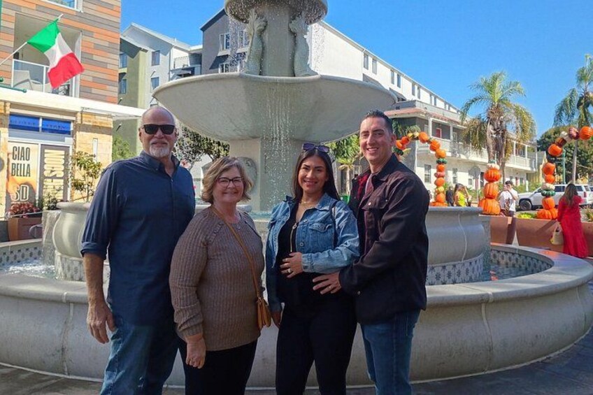 A fountain with people standing in front of it. 3