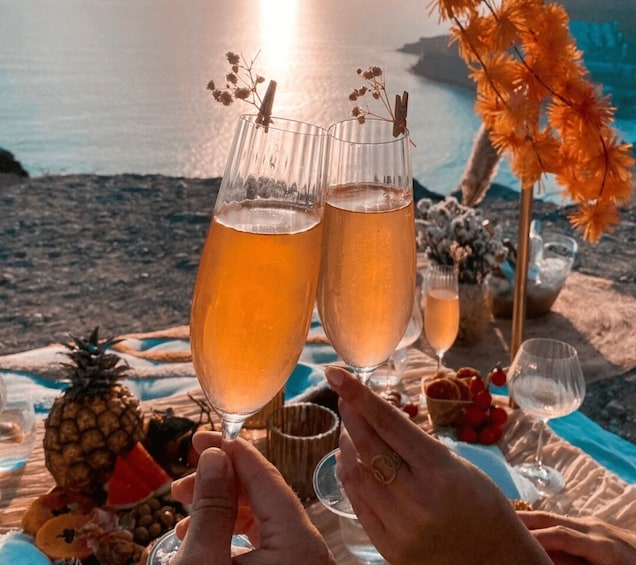 Two champagne flutes with a tropical drink, a beach setting, and a sunset in the background. 3