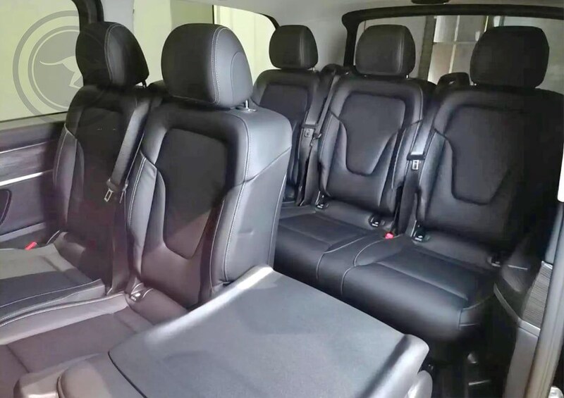 A car interior with black leather seats and a center console. 5