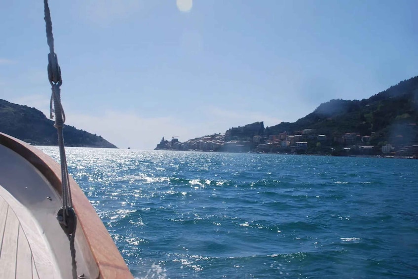 A boat on a calm sea with a coastline in the background. 4