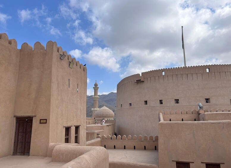 A fortress with a minaret and a dome, surrounded by a moat. 3