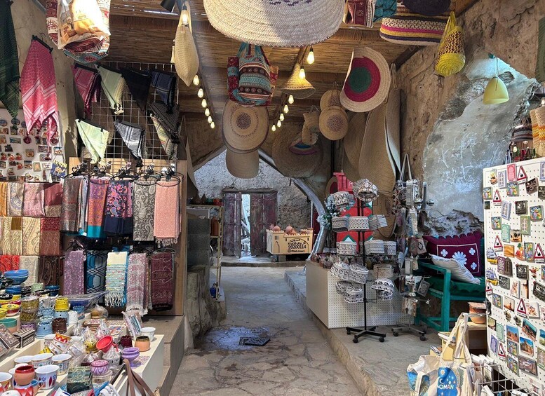A market with various textiles, pottery, and woven baskets. 5