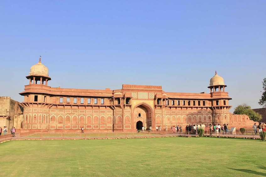 A large, historic building with two domes and a central archway. 2