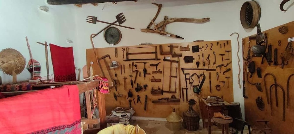 A room with various tools and objects displayed on the walls. 4