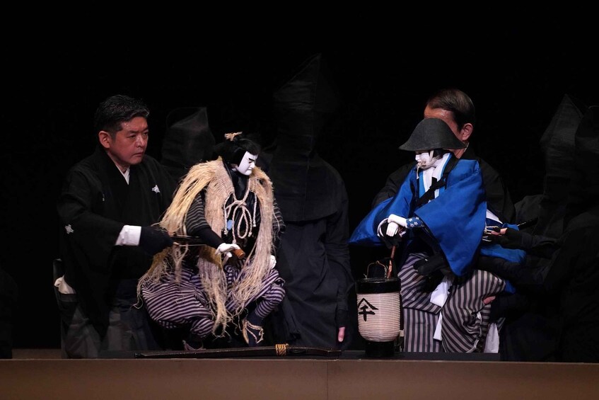 A group of people in traditional Japanese attire on a stage. 2