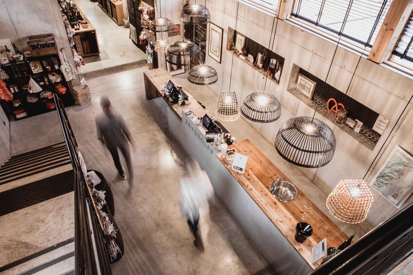 A modern interior with a central counter, hanging lights, and various items displayed on shelves. 5