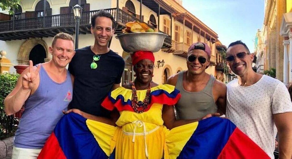 A group of people posing in a historic street with colonial architecture. 2