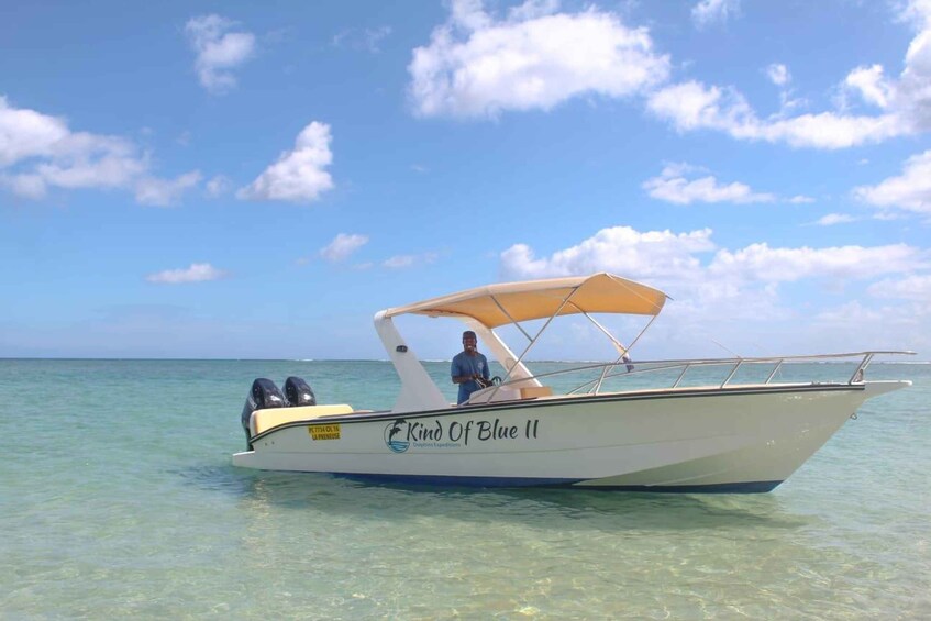A boat named 'Kind Of Blue II' on calm turquoise waters. 2