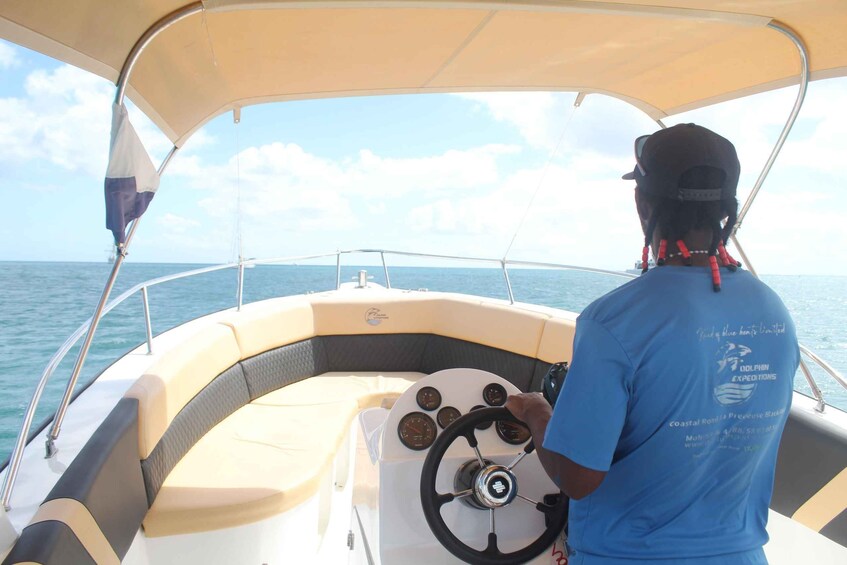 A person steering a boat on the water. 4