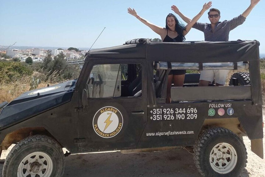 A black off-road vehicle with a logo and contact information on the side. 3