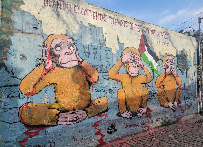 A mural with three figures in yellow, sitting and holding their heads in distress, with a cityscape in the background. 2