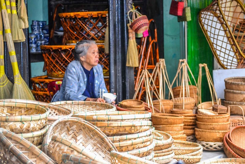 A market stall with various woven baskets and a person sitting behind the stall. 4