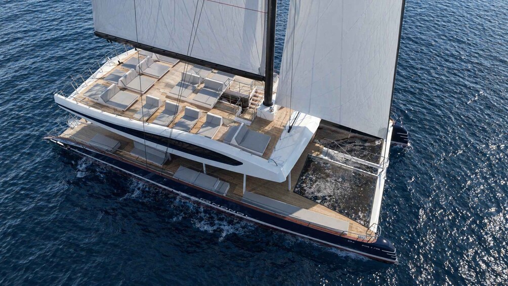 A sailboat with a deck lounge area and a cabin. 4