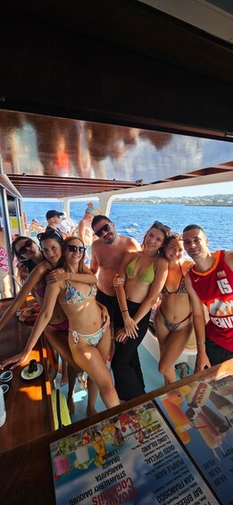 A group of people on a boat with a menu in the foreground. 5
