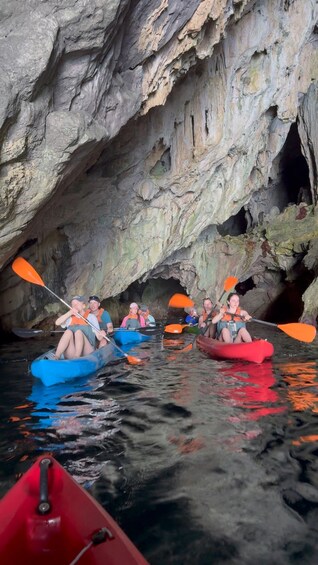 People kayaking in a cave. 5