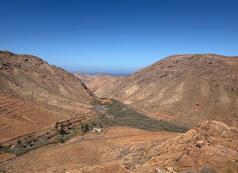 A rugged mountainous landscape with a clear sky. 2