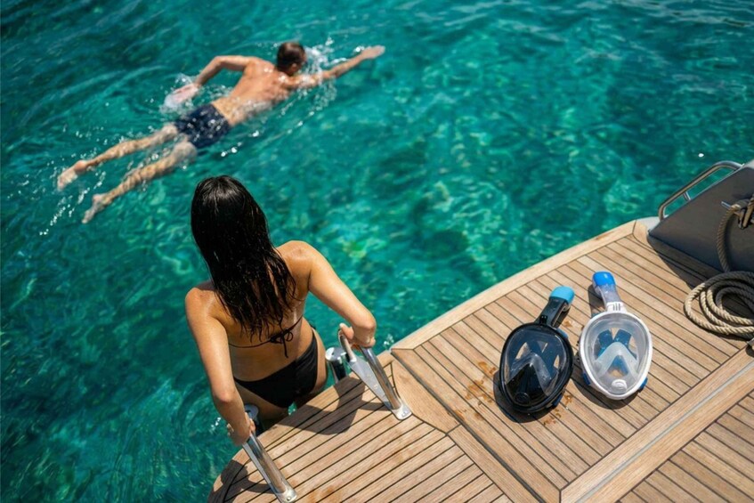 A person snorkeling in clear water, a boat deck with snorkeling gear, and another person swimming in the background. 2