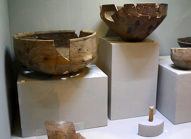 A collection of ancient pottery on display. 4