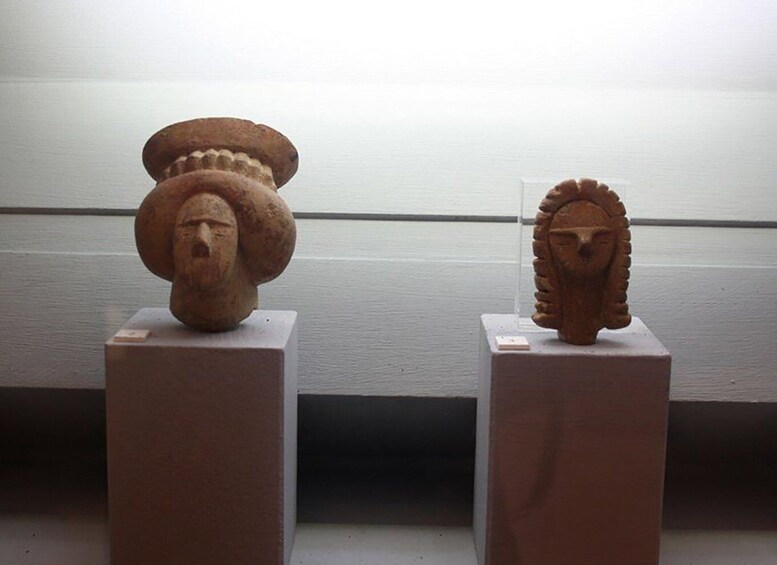 Two ancient stone sculptures on pedestals. 5