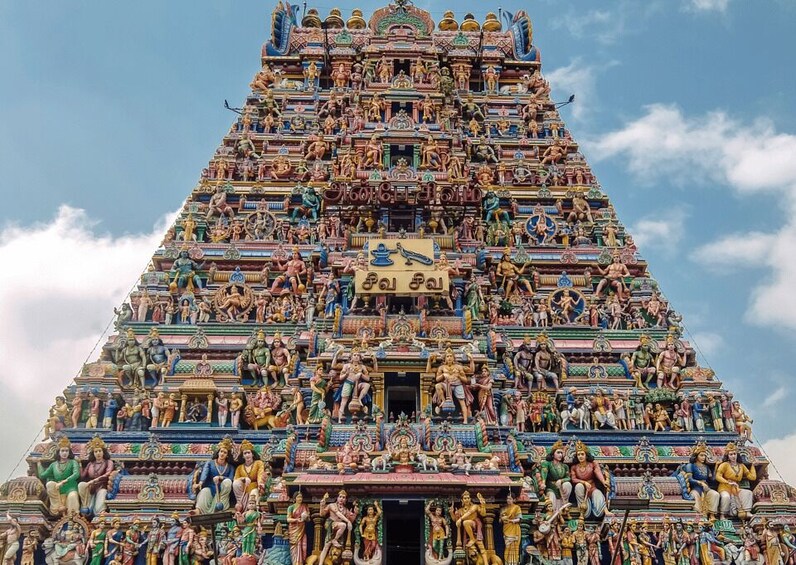 A multi-tiered temple with intricate carvings and statues. 5