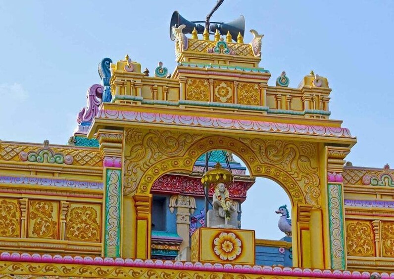 A colorful temple entrance with intricate carvings and statues. 1