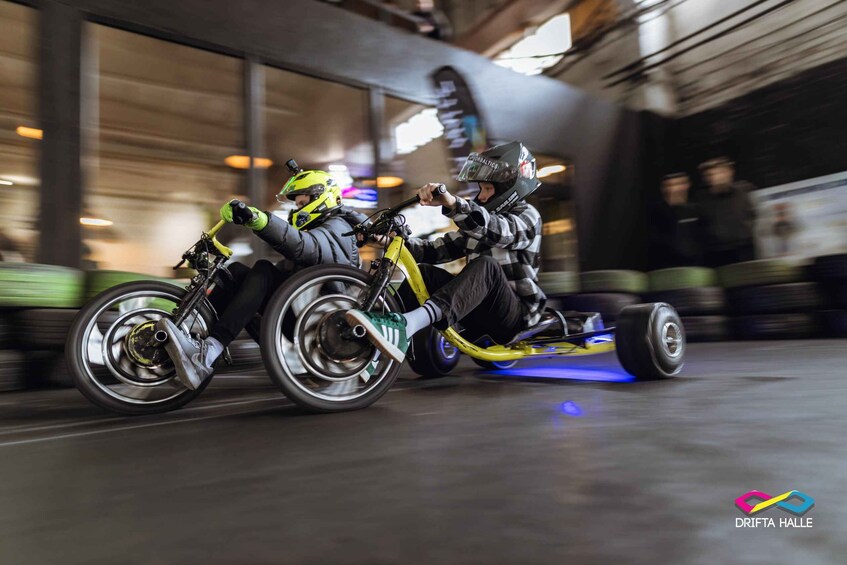 Two people riding a go-kart on a track. 5