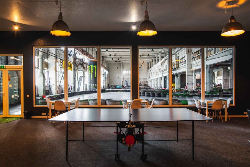 A conference room with a large table, chairs, and a Monster Energy bike. 3