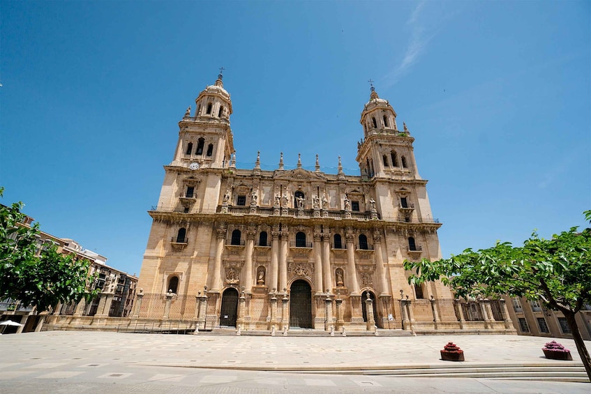 A large historic cathedral with two towers and intricate facade details. 1