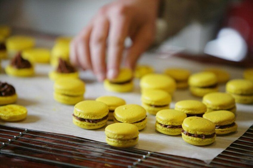Yellow macarons on a baking sheet. 2