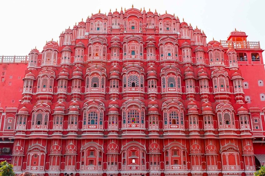 A large, ornate building with intricate red and white patterns and multiple domes. 1