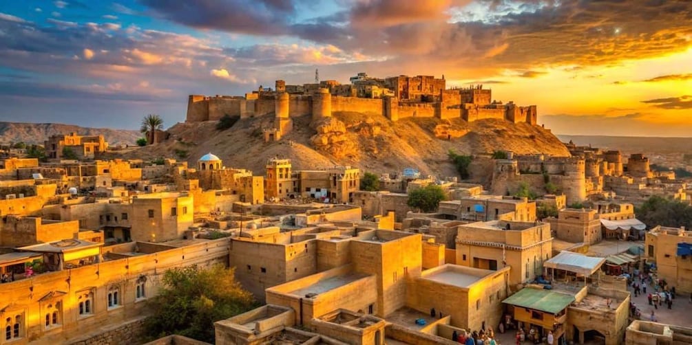A historic walled city with a prominent fort on a hill, surrounded by traditional buildings. 1