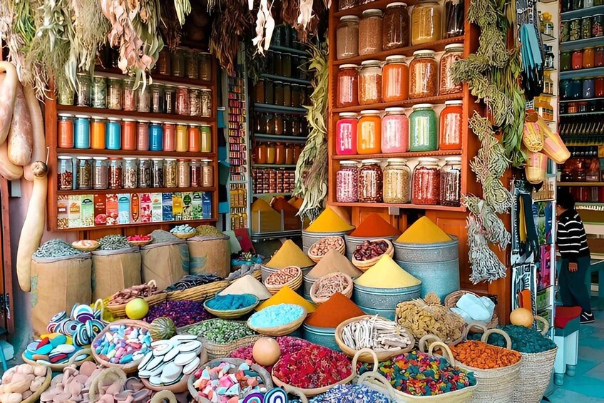 A market stall with colorful spices and dried goods displayed in baskets and jars. 2