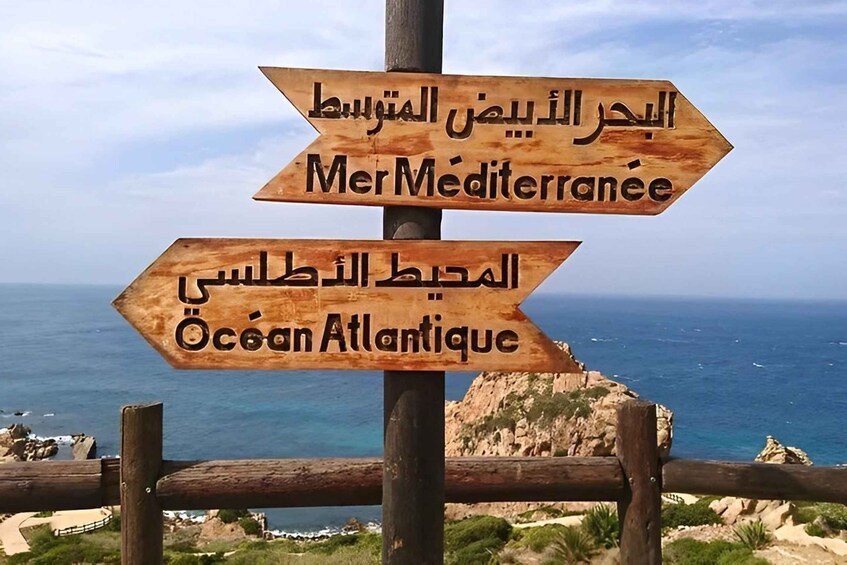 A wooden signpost with directions to Mer Mediterranee and Océan Atlantique. 1