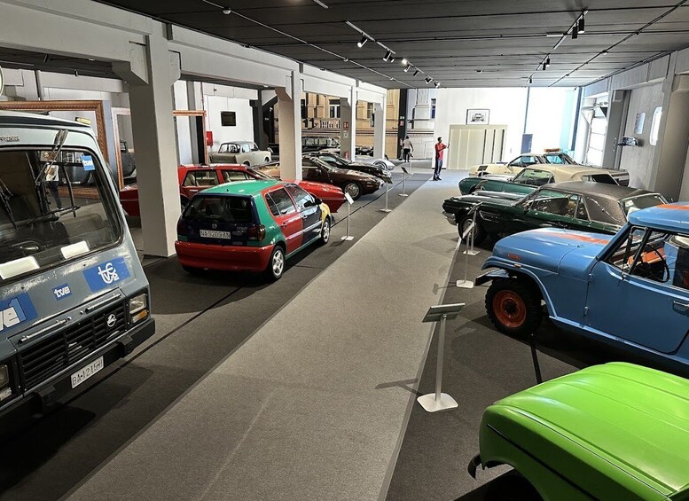 A museum with vintage cars on display. 3