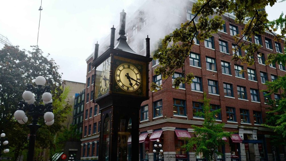 A historic clock tower with a steam engine in the background. 4
