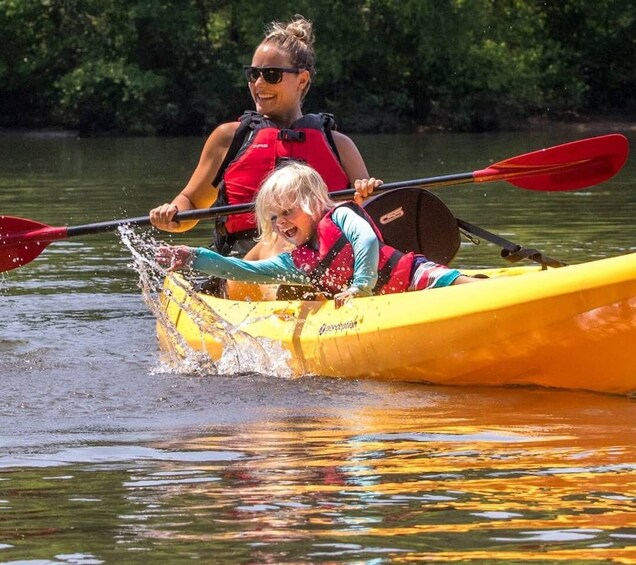 Two people kayaking on a river. 2