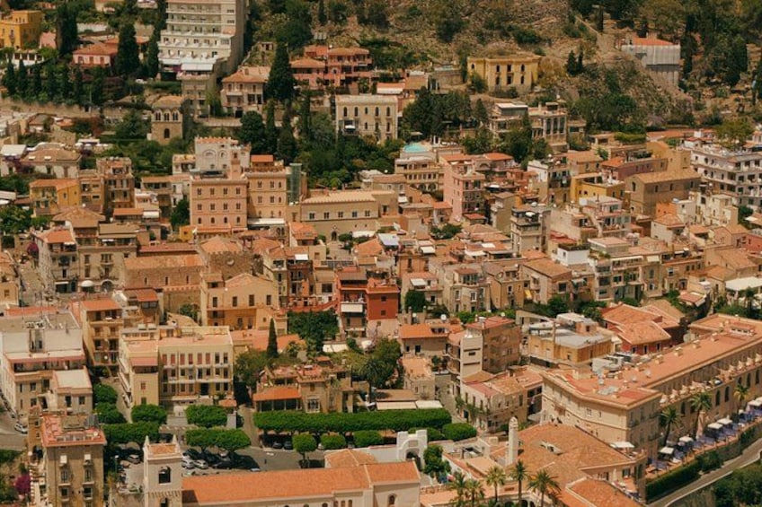 A densely packed urban area with historic buildings, narrow streets, and a prominent church. 4