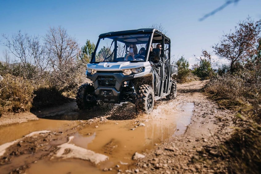 A 4x4 vehicle navigating a muddy off-road trail. 1