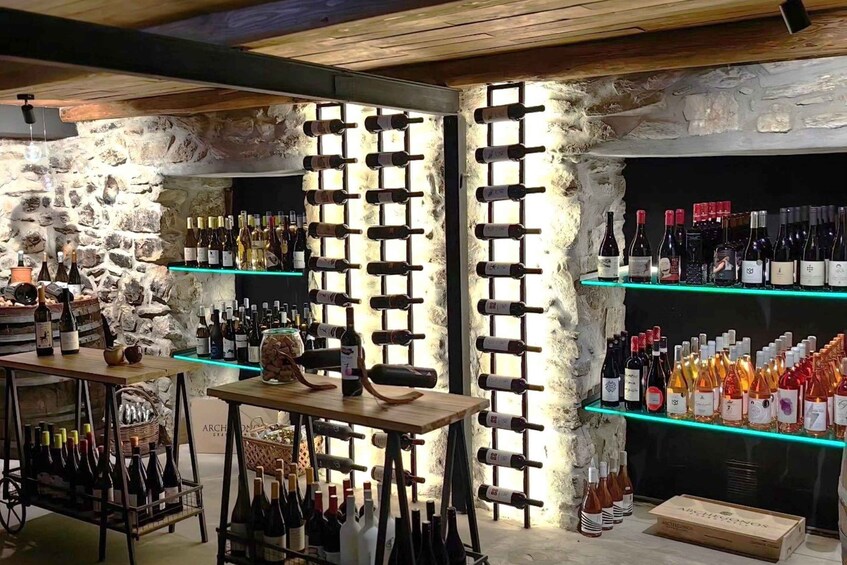 A wine cellar with wooden shelves and a stone wall. 3