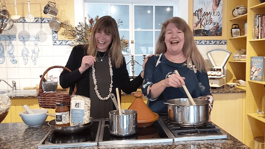 Two people cooking in a kitchen with various utensils and ingredients. 3