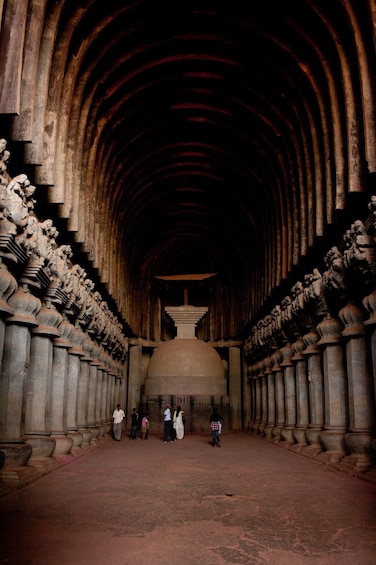 A grand, arched corridor with intricate stone carvings and a large central dome. 2