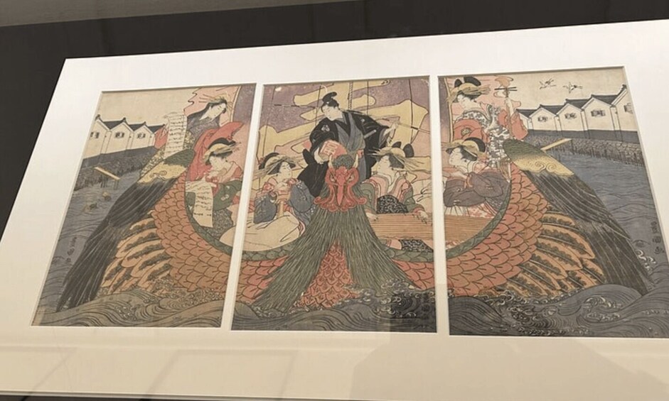A framed triptych of traditional Japanese artwork depicting a scene with figures on a boat. 4