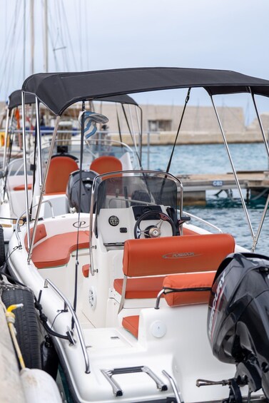 A row of boats docked at a marina with a clear sky. 2