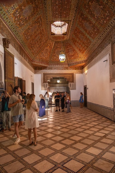 A historic building with ornate tile work and a high, intricately patterned ceiling. 4