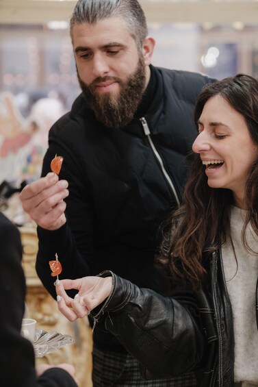 A person holding a lollipop. 5