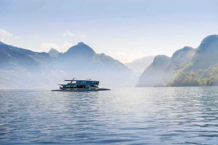 A boat on calm water surrounded by mountains. 2
