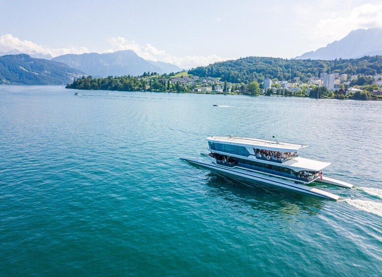 A white boat with a flat deck sailing on a calm lake. 1